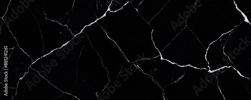 Black and White Marble Texture. Close-up of a striking marble surface featuring a dramatic contrast between deep black and pure white sections. Intricate veining patterns create a natural.