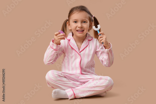 Happy little girl in pajama...