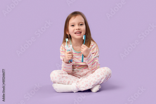 Happy little girl in pajama...