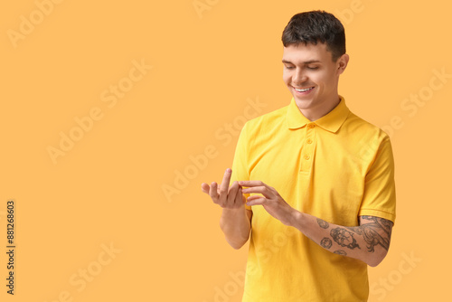 Smiling young man in yellow...