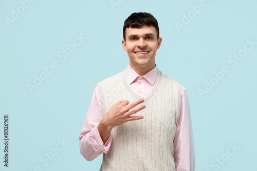 Smiling young man showing t...
