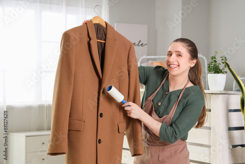 Young female worker cleanin...