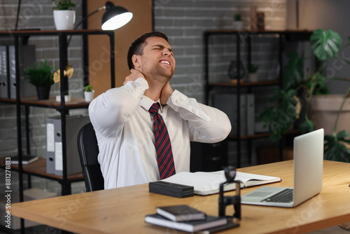 Young businessman suffering...