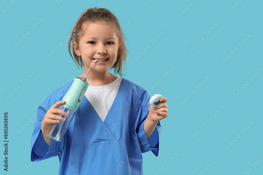 Cute little dentist with oral irrigator and dental floss on blue background Cute little dentist with oral irrigator and dental floss on blue background