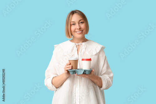 Smiling woman holding two d...