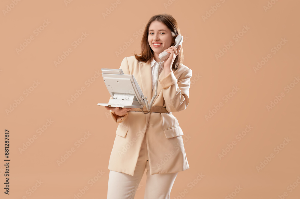 Fototapeta premium Pretty businesswoman talking on phone on beige background