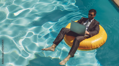 businessman in pool with computer
