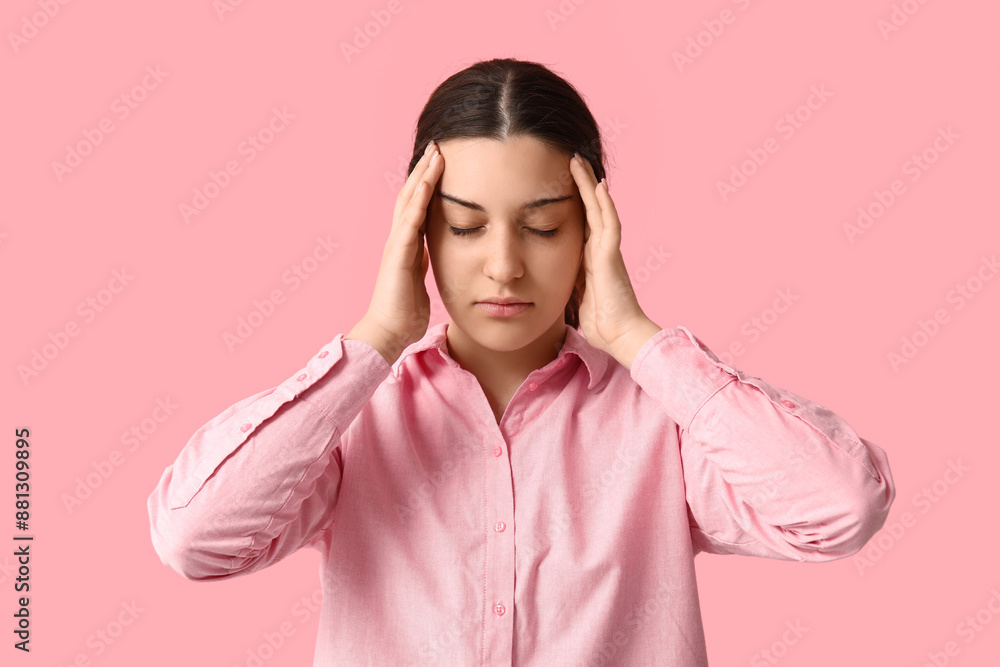 Beautiful young woman suffering from headache on pink background Beautiful young woman suffering from headache on pink background