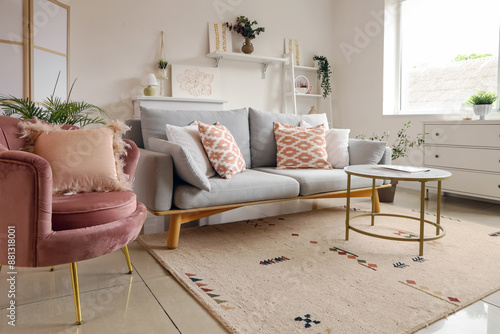 Tableau sur toile Cozy sofa, armchair, coffee table and pictures in living room