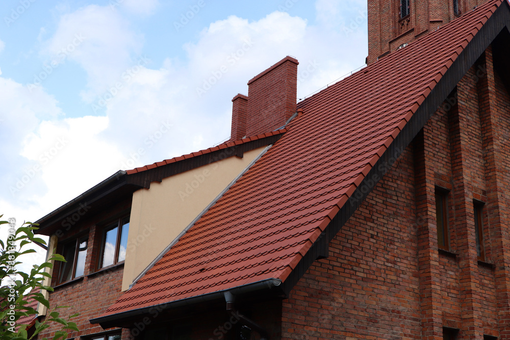 View of beautiful house with brown roof against blue sky View of beautiful house with brown roof against blue sky
