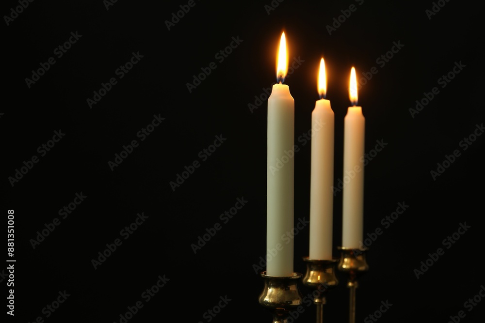 Burning candles on black background. Space for text Burning candles on black background. Space for text