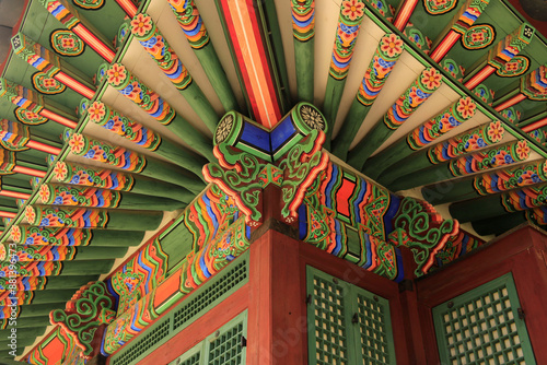 Low angle view of corner of tile house with colorful dancheong and eaves at Deoksugung Palace near Jung-gu, Seoul, South Korea
 photo