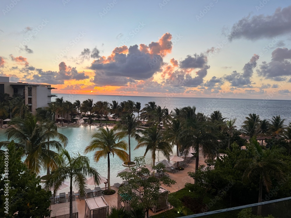 Obraz premium Sunset over beach and pool