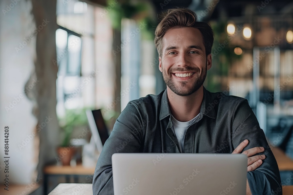 Happy confident man working remotely on laptop in cozy cafe warm and inviting work environment concept Happy confident man working remotely on laptop in cozy cafe warm and inviting work environment concept