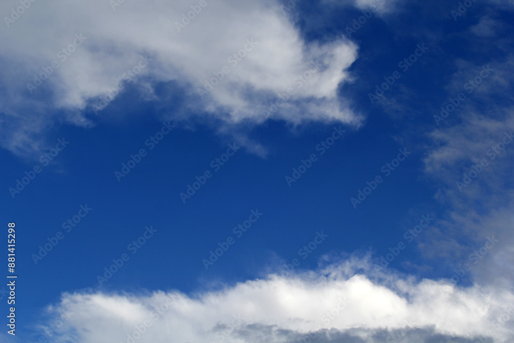 Blue sky with scattered white clouds abstract background Blue sky with scattered white clouds abstract background