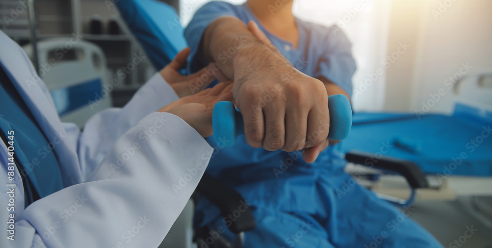 Physiotherapist man giving exercise with dumbbell treatment About Arm and Shoulder of athlete male patient Physical therapy concept Physiotherapist man giving exercise with dumbbell treatment About Arm and Shoulder of athlete male patient Physical therapy concept
