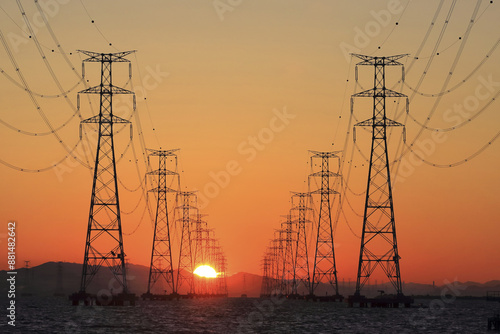 Sunrise view of transmission towers on Sihwa Lake against glow in the sky near Ansan-si, South Korea
 photo