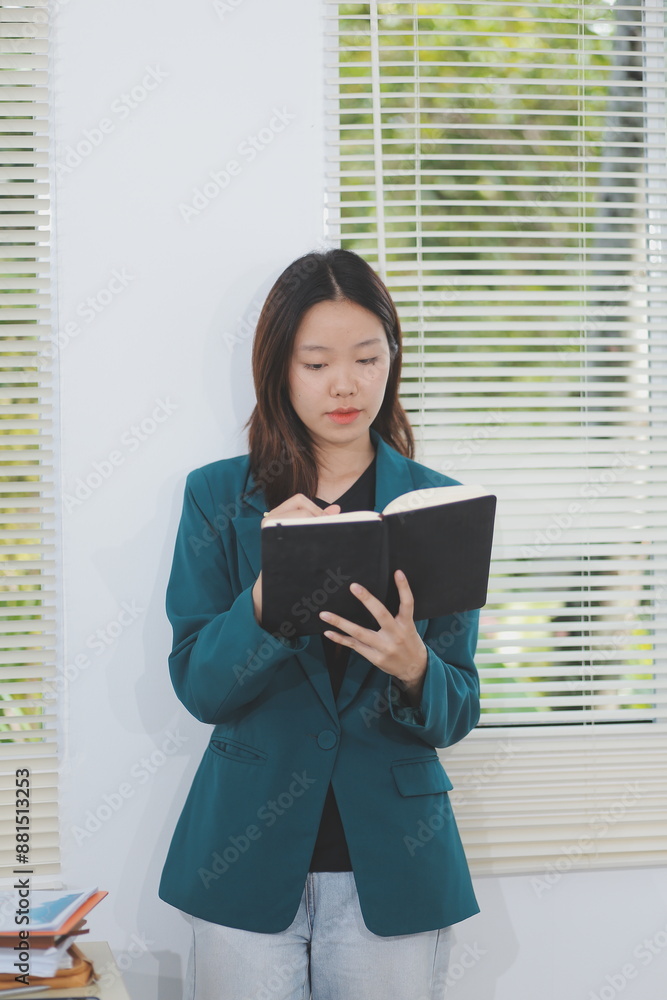 business woman working with laptop while consulting some invoice and document in working space at home business woman working with laptop while consulting some invoice and document in working space at home