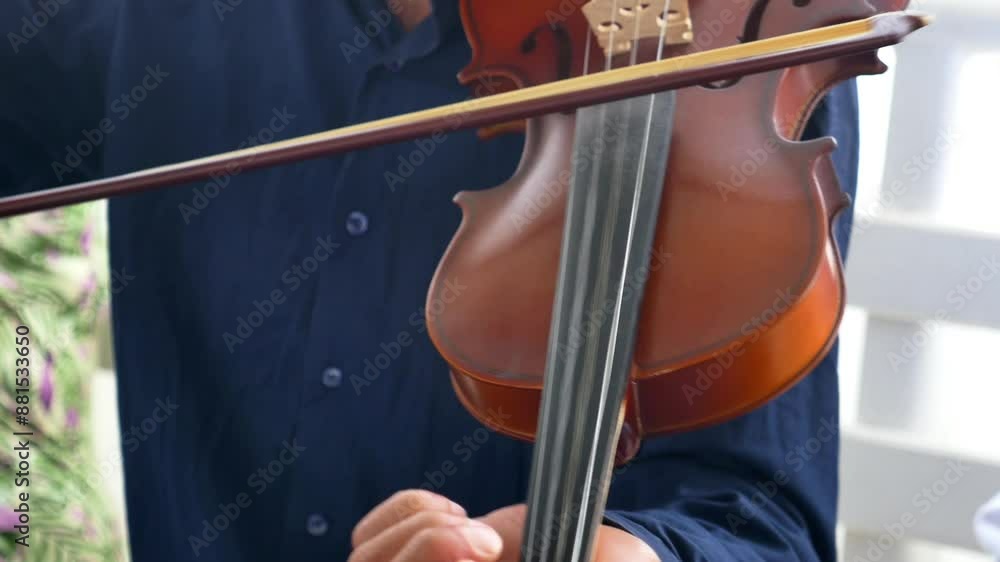 Closeup view of a musician playing the violin with focus on the hands and instrument details Closeup view of a musician playing the violin with focus on the hands and instrument details