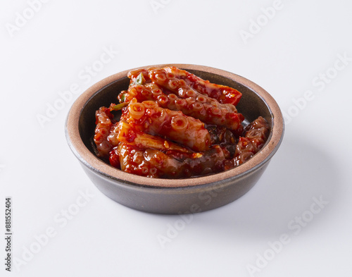 Close-up of Nagji Jeotgal(salted long-legged octopus) on small jar bowl and white floor, South Korea 