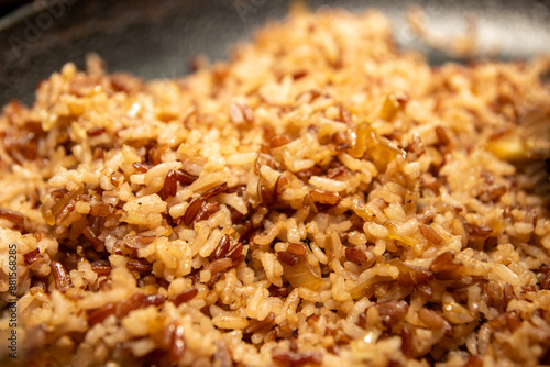 Canvas Print Close-up view of steaming brown rice - glossy sheen and visible grains  captured in natural light, highlighting the texture and warmth of a freshly cooked staple
