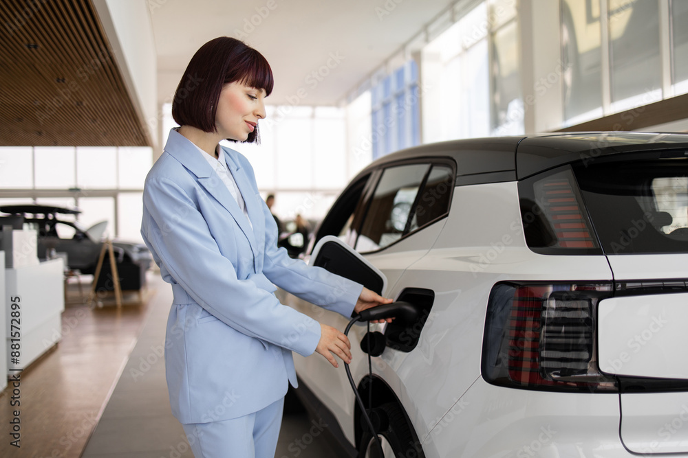 Businesswoman in blue suit purchasing electric SUV at car dealership. Concept of sustainable transportation and eco-friendly vehicles. Businesswoman in blue suit purchasing electric SUV at car dealership. Concept of sustainable transportation and eco-friendly vehicles.