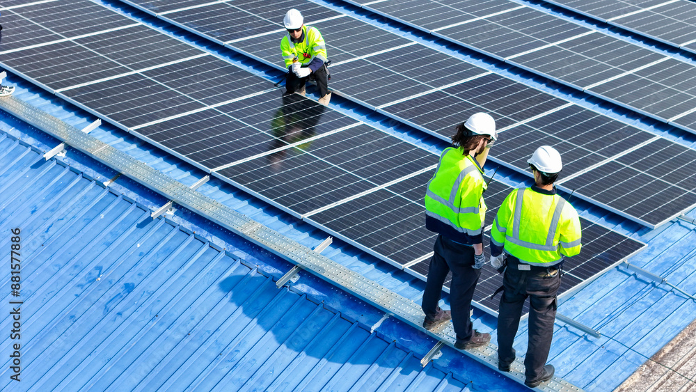 Worker Technicians are working to construct solar panels system on roof. Installing solar photovoltaic panel system. Men technicians walking on roof structure to check photovoltaic solar modules. Worker Technicians are working to construct solar panels system on roof. Installing solar photovoltaic panel system. Men technicians walking on roof structure to check photovoltaic solar modules.
