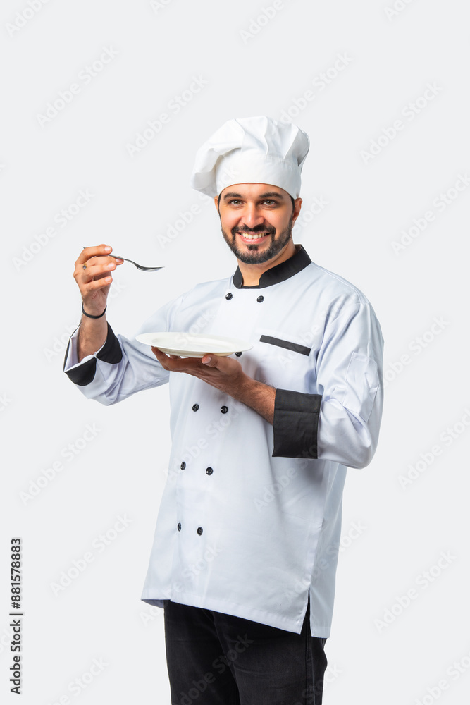 Indian asian young Chef in uniform happily presenting empty white ceramic plate on white background Indian asian young Chef in uniform happily presenting empty white ceramic plate on white background