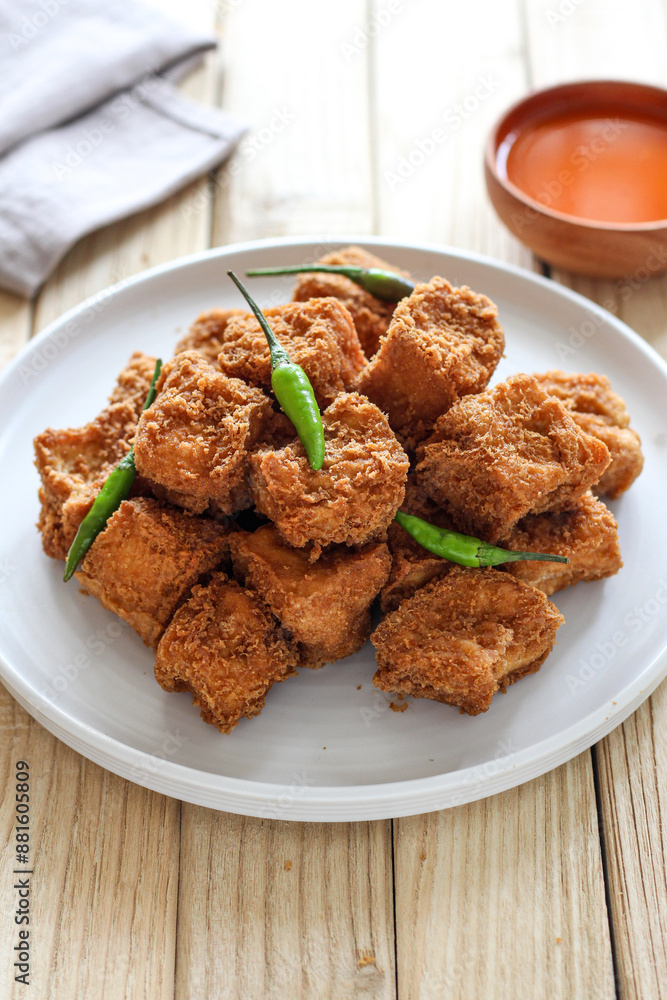 Sumedang tofu (tahu sumedang) on a wooden table. Perfect for recipe, article, catalogue, or any commercial purposes. Sumedang tofu (tahu sumedang) on a wooden table. Perfect for recipe, article, catalogue, or any commercial purposes.