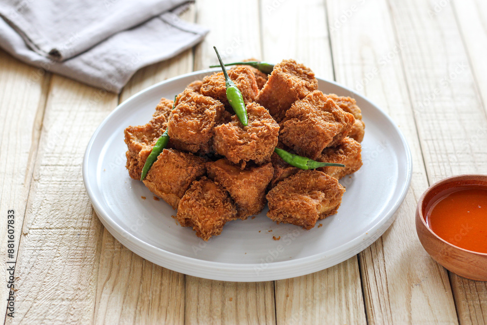 Sumedang tofu (tahu sumedang) on a wooden table. Perfect for recipe, article, catalogue, or any commercial purposes. Sumedang tofu (tahu sumedang) on a wooden table. Perfect for recipe, article, catalogue, or any commercial purposes.