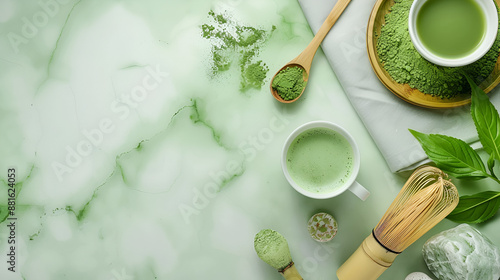 Green matcha tea drink and tea accessories on green marble background