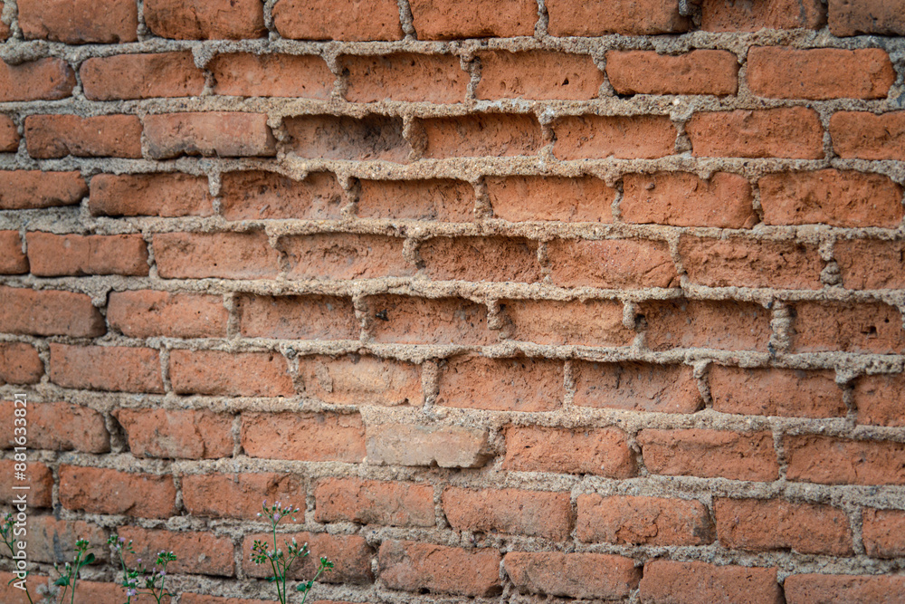 A brick wall with a hole in it. The wall is made of red bricks A brick wall with a hole in it. The wall is made of red bricks