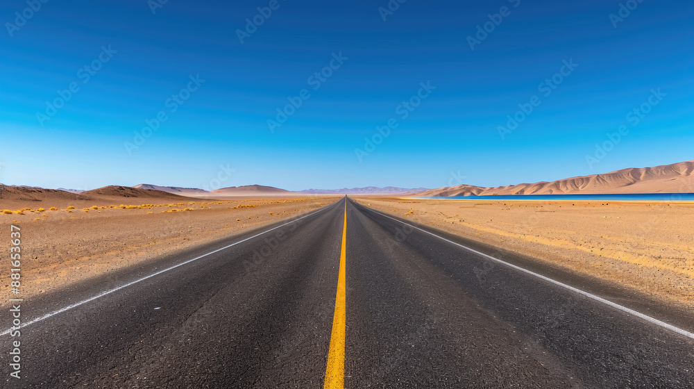 Fototapeta premium The image shows a long, straight road stretching into the distance