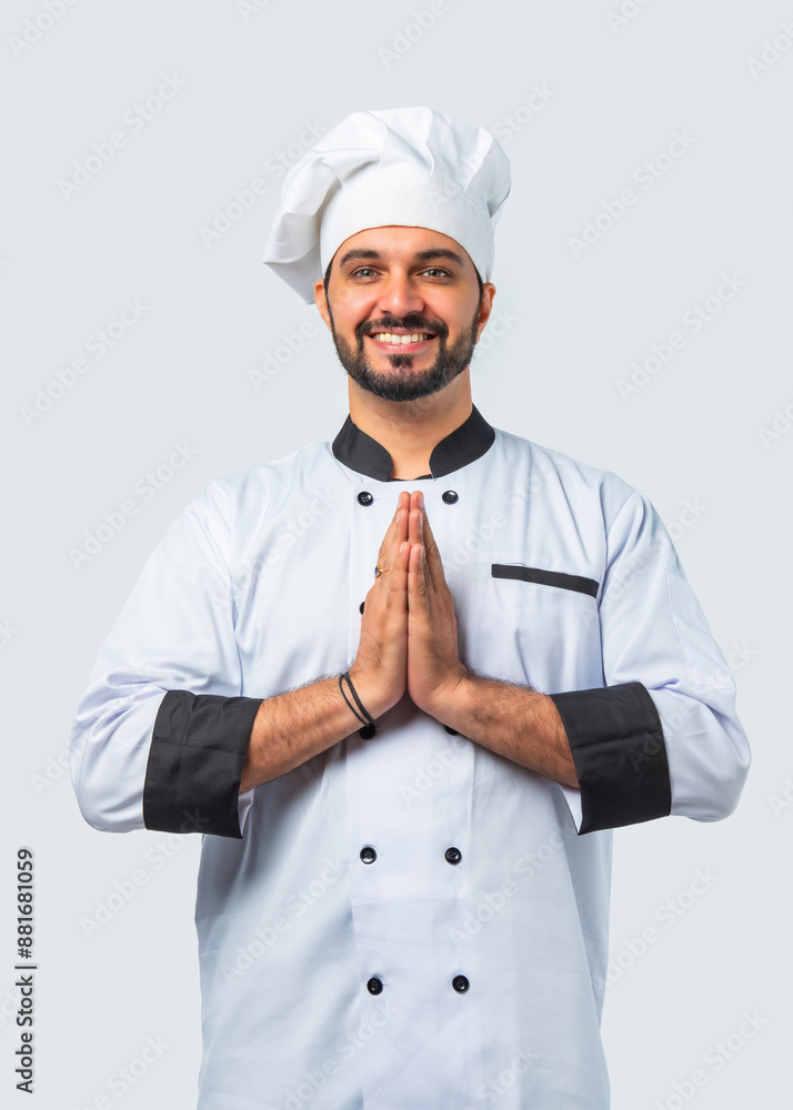 Smiling Asian Indian chef or professional cook with folded hands, isolated white background. Smiling Asian Indian chef or professional cook with folded hands, isolated white background.