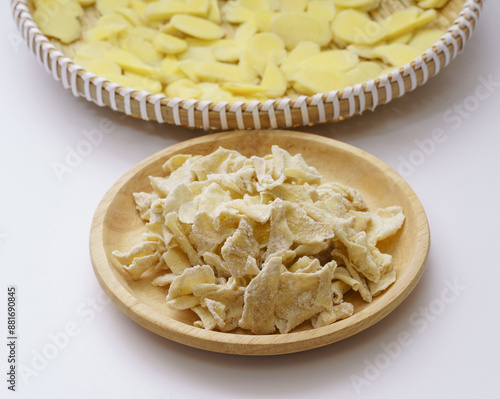 Close-up of Ginger Jeolpyeon on wood tray with sliced raw yellow ginger pieces on bamboo basket, South Korea
 photo