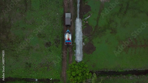 Jeep boat trailer surf boards sunrise early morning Teahupoo Tahiti French Polynesia aerial drone birdseye end of the road Olympic venue surf village town buildings coastline Pass Havea coral reef photo