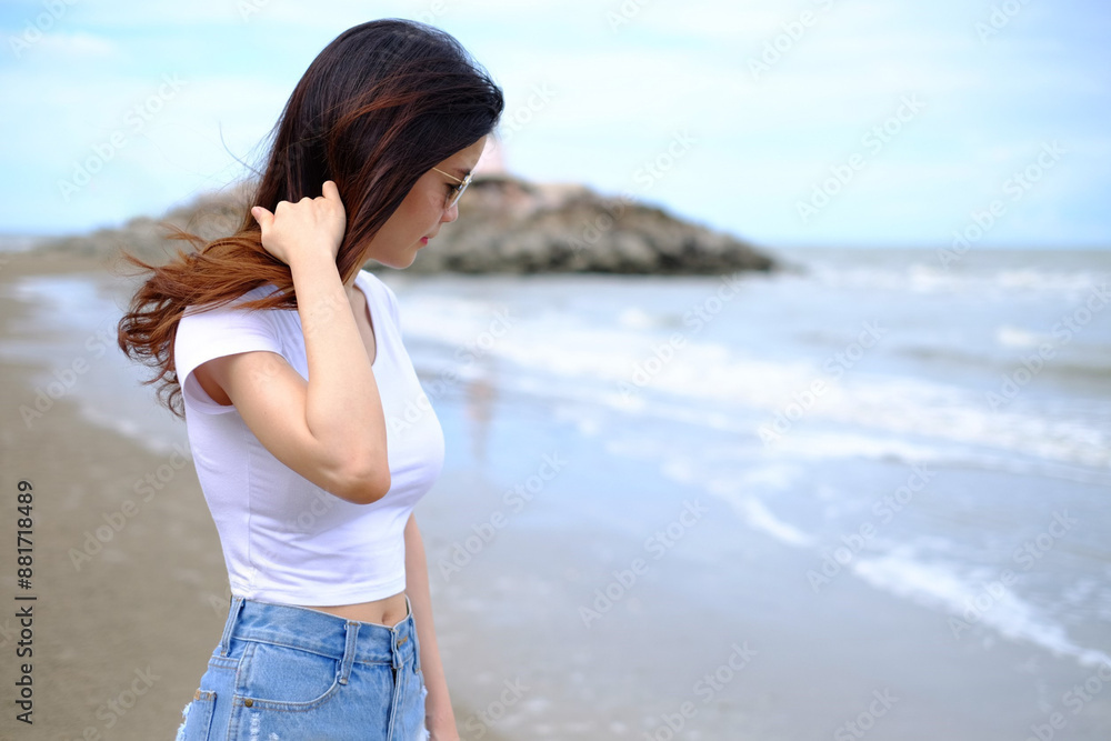 Summer beach background. Portrait young Asian woman with a white shirt in vacation travel. Summer beach background. Portrait young Asian woman with a white shirt in vacation travel.