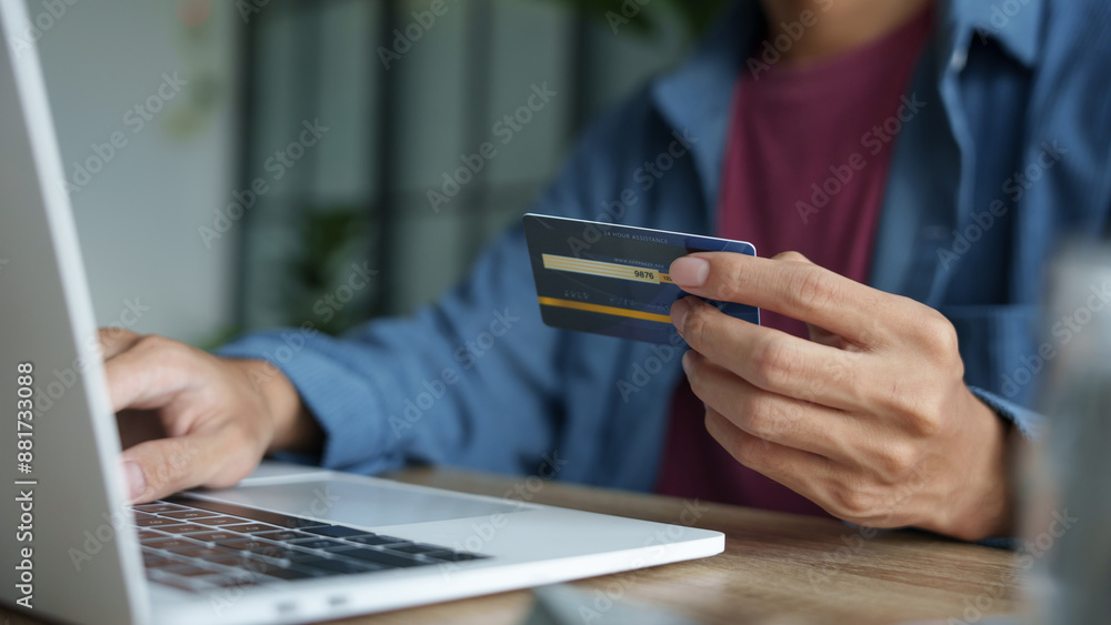 Businessman hold credit card online payment in laptop. Businessman hold credit card online payment in laptop.