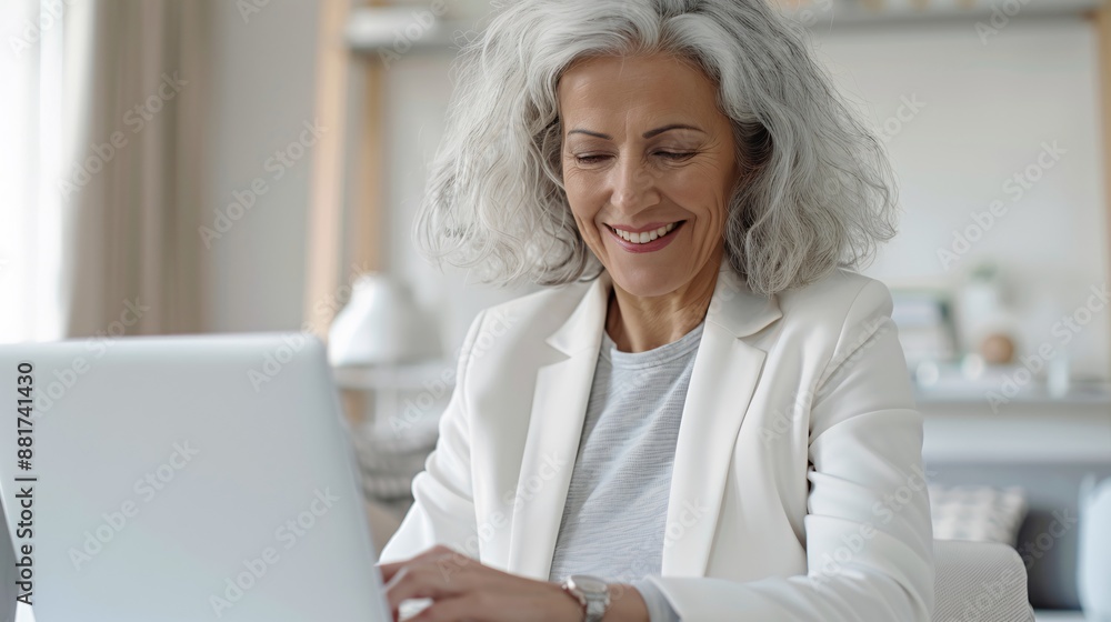 Mid-aged woman smiling while looking at a photo frame on her desk, reminiscing about happy moments during a quiet office moment, soft-focus background. Mid-aged woman smiling while looking at a photo frame on her desk, reminiscing about happy moments during a quiet office moment, soft-focus background.
