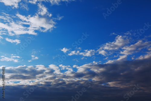 Sky is blue with a few clouds scattered throughout. Morning clouds are white and fluffy, giving the sky a dreamy appearance