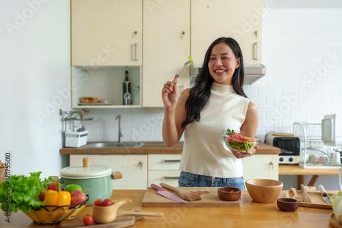 Diet to maintain figure. Fresh food is important for weight loss and perfect health. woman cutting vegetables Tomatoes into a bowl to make a salad to eat at home. Health care concept.