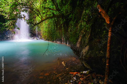 Beautiful waterfalls with blue water in the tropical forest. Curug Cipondok west java Subang Indonesia. Tranquil nature scenery for wallpaper background.  photo