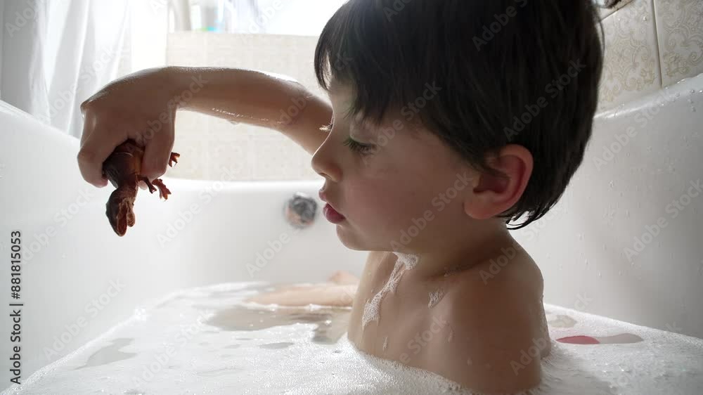 Boy playing with a toy dinosaur during bath time, immersed in a bubble bath. The moment captures his concentration and the simple pleasures of childhood, surrounded by the white bathtub Boy playing with a toy dinosaur during bath time, immersed in a bubble bath. The moment captures his concentration and the simple pleasures of childhood, surrounded by the white bathtub