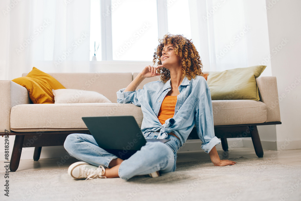 Smiling woman working on laptop, enjoying freelance job in cozy, modern living room. Smiling woman working on laptop, enjoying freelance job in cozy, modern living room.