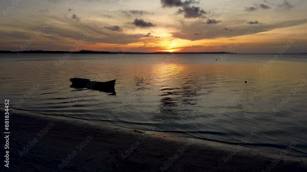 Sunset at Candaraman Island in Balabac. The sun sets behind the horizon, creating a breathtaking view of the sky and its reflection on the tranquil waters. Sunset at Candaraman Island in Balabac. The sun sets behind the horizon, creating a breathtaking view of the sky and its reflection on the tranquil waters.