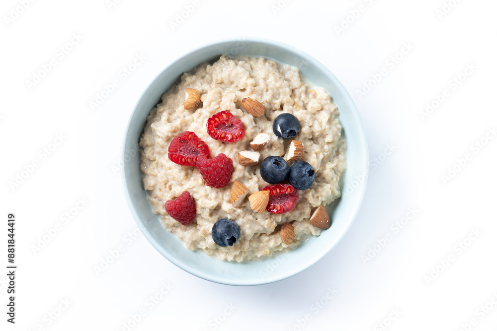 Oatmeal porridge with raspberries, blueberries and almonds in bowl isolated on white background. Top view Oatmeal porridge with raspberries, blueberries and almonds in bowl isolated on white background. Top view