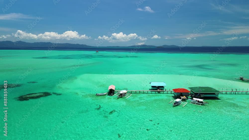 The drone captures the arrival spot on Onok Island, showcasing the vivid emerald waters and pontoon bridges that lead to secluded swimming and relaxation spots. The drone captures the arrival spot on Onok Island, showcasing the vivid emerald waters and pontoon bridges that lead to secluded swimming and relaxation spots.