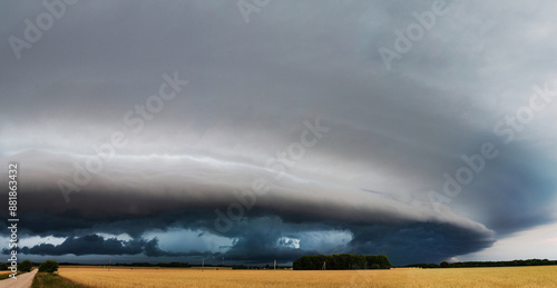 WEATHER - Dramatic Dark Rain Clouds over Fields and Country Road. Shelf Cloud, Supercell, Cyclone, Storm, Lithuania photo