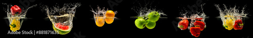 Group of falling fruits and vegetables in water with splash on black background