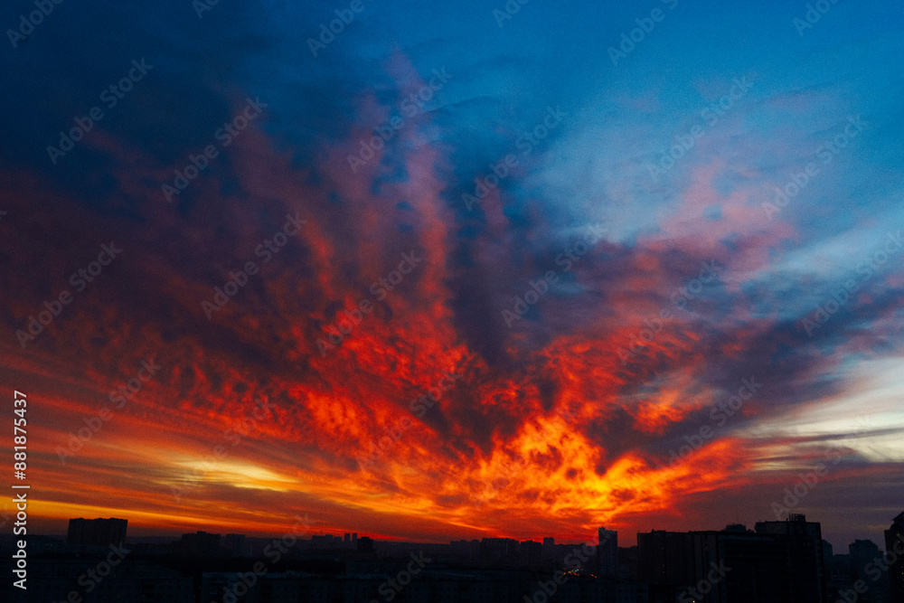 evening sky over the city, scarlet clouds in the setting sun, red sunset over the city evening sky over the city, scarlet clouds in the setting sun, red sunset over the city